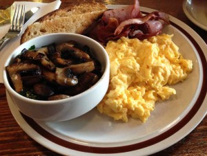 Breakfast of scramble eggs mushrooms and bacon - ordered separately